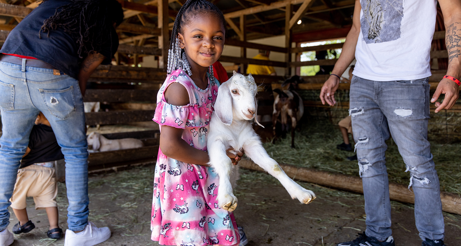 girl holding a goat