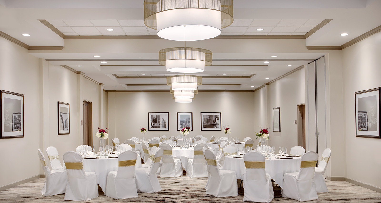 ballroom set up with white table cloths and gold accents